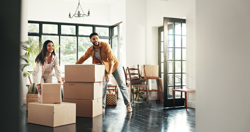 Buyer, moving and couple with boxes, real estate and ownership of property with mortgage and lounge. Relocation, happy and people with cardboard in living room, investment and purchase with home loan
